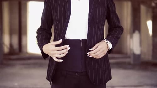 Woman Buttoning Fashionable Pinstripe Suit Jacket Indoors