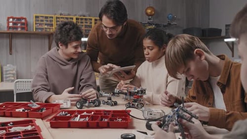 Teacher Explaining Something To Kids At Robotic Class