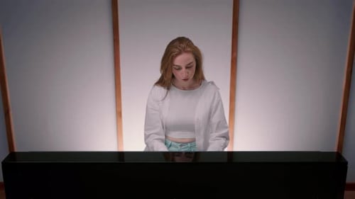 Close-up: a woman sensually plays the piano