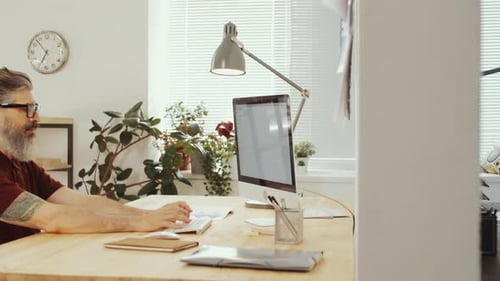Mixed-Age Colleagues Working on Computers in Office