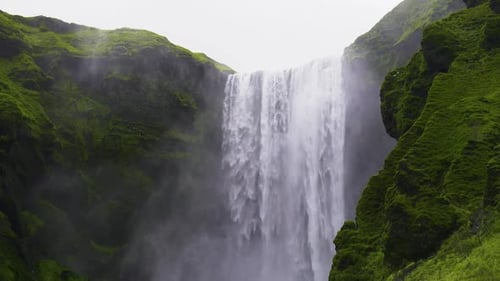 Majestic Waterfall Cascading Through Lush Green Landscape