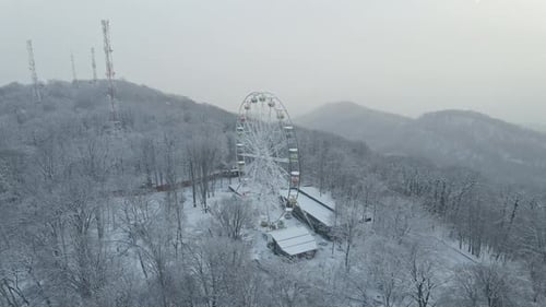 Ferris Wheel on Top of Mount Akhun During a Snowfall