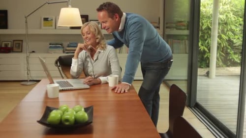 Married Couple Working on a Laptop at Home