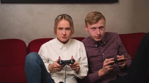 Young Couple Plays Video Games on Couch