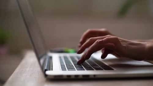 Close-up of Hands of Unrecognizable Woman Working Laptop Computer Keyboard.