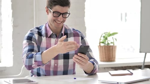 Young Adult Waving During a Video Call