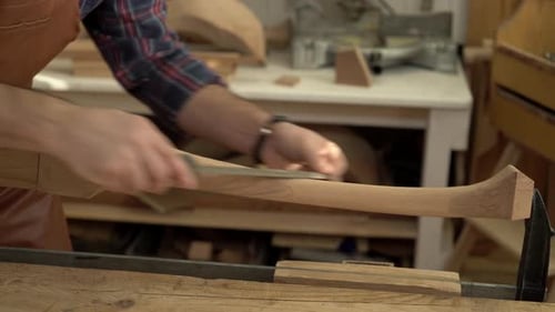 Carpenter Polishes Cabrioli Leg in his Workshop