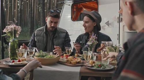 Happy People Enjoying Dinner at Campground
