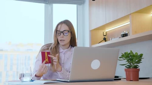 Woman Teaches Online Class with Flashcards and Laptop