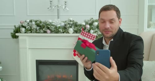 Close-up of Happy Young Man Communicating By Video Call. Young Man Waving at Camera and Talking