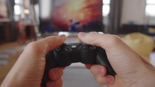 Hands Holding Controller While Playing Video Game