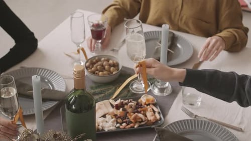 People Celebrating with Champagne at Dining Table