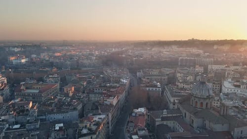 Flying over the city of Rome at daybreak