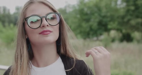 Young Woman with Glasses Posing Outdoors