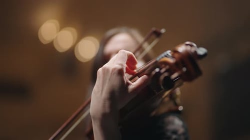 Closeup View of Old Viola in Hands of Young Woman Musician is Playing Music on Concert