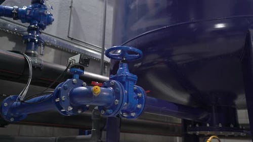 Blue Pipes and Valves in Industrial Setting