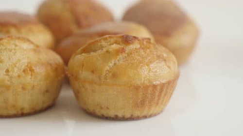 Tasty cornbread as a muffin slow tilt 4K 2160p 30fps UltraHD footage - Healthy cornmeal on white pla