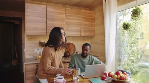 Young Couple at Home Drinking Coffee Together