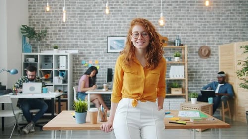 Slow Motion of Pretty Smiling Girl Standing in Office Looking at Camera