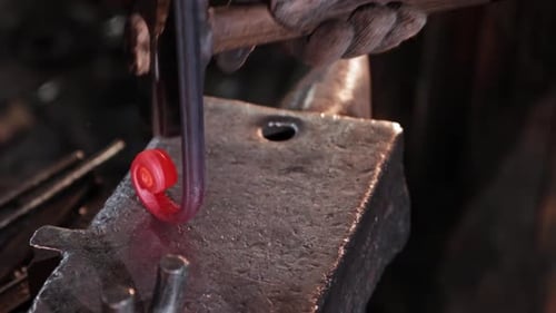 Hammer Shaping Red Hot Metal on Anvil