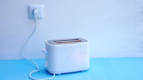 White Toaster on Blue Countertop Heats Up