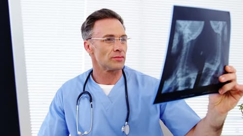 Male doctor examining an x-ray