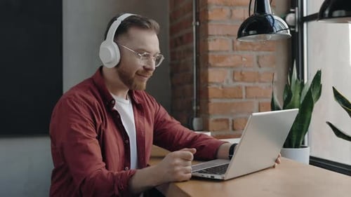 Young Adult Man Working from Office on Laptop