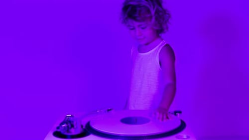 Child Plays Music on a Record Player