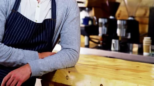Happy Man Smiling at Cafe Counter