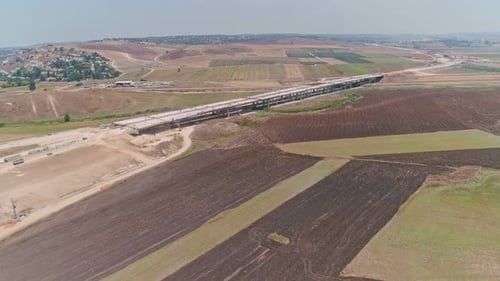 Aerial footage of large highway construction project with tunnels and bridges