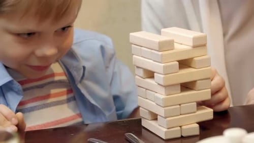 Child and Woman Play Tower Building Game