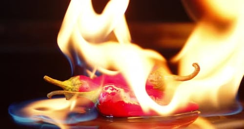 Hot Red Pepper Burns in the Flame of Bright Fire.