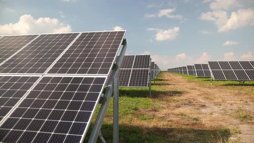 Solar Panel Array in Rural Field on Sunny Day