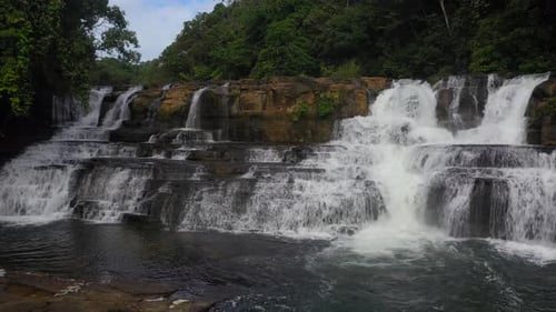 Cascading Waterfall in Lush Tropical Rainforest