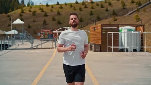 Young man running fast and intense in forest