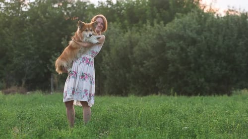 Smiling Woman Holding A Dog