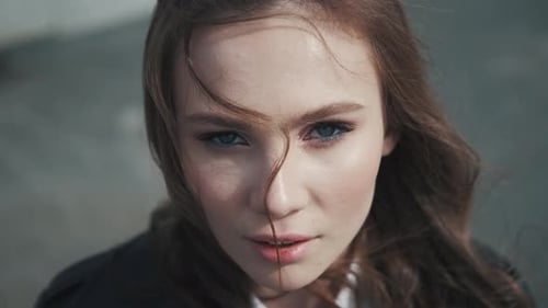 Beautiful Woman in Urban Setting with Windblown Hair