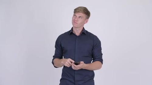 Blond Man Using Mobile Phone Then Smiling