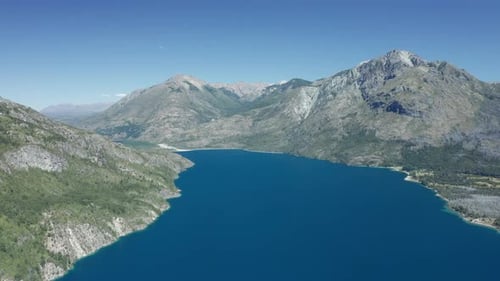 Drone Over Deep Blue Water In Between Mountains