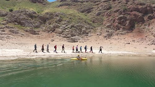 People Walking By The Lake And Canoeing On The Lake 2