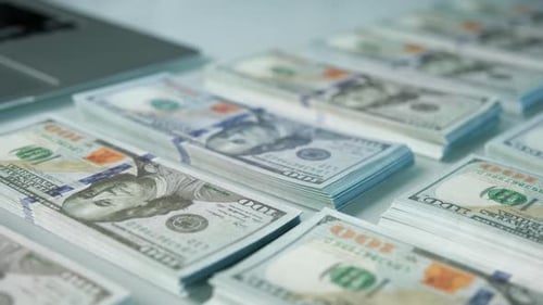 Stacks of Hundred Dollar Bills on Table