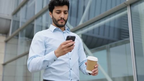 Handsome Business Man With Phone And Coffee On Street