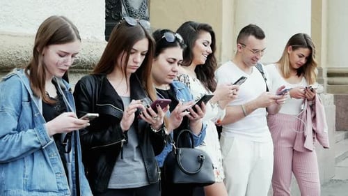 Young People on Phones in City Setting