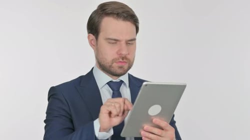 Man in Business Suit Uses Tablet Device