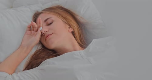 Woman Waking Up and Stretching in Bed