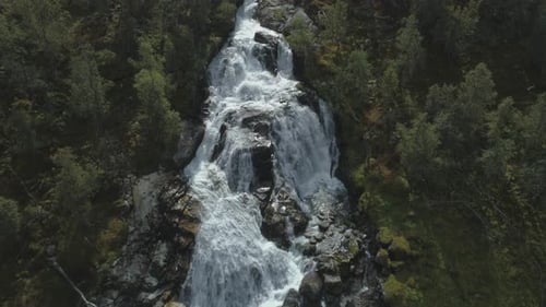Waterfall, Rocks and Green Trees in Norway. Aerial View