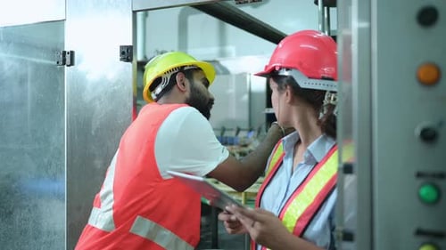 Female chief engineer of a mechanical plant Inspecting and explaining the maintenance of the machine