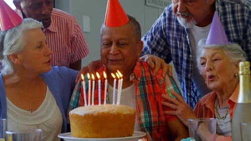 Seniors Celebrating Birthday with Cake and Friends