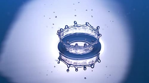 700671 Drop of Water falling into Water against Blue background, Slow motion