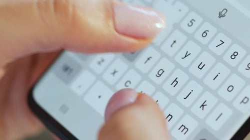 Hands Typing Text on Smartphone Close-up